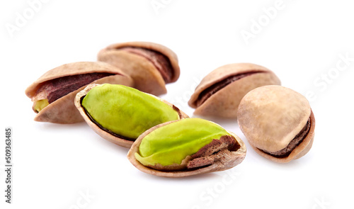 Salted Pistachio nuts in closeup isolated on white background.