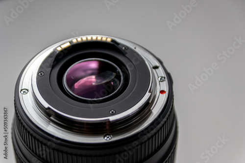 Back side of a dslr camera lens objective for professional photography with camera mount details in macro view with beautiful lens details for optical precision in portrait photography