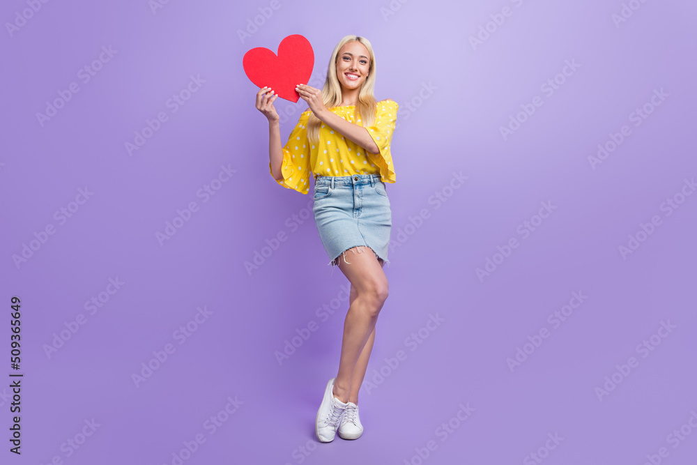 Full size photo of cute adorable lady express her feelings to boyfriend hold red paper heart isolated on violet color background Full size photo of cute adorable lady express her feelings to boyfriend hold red paper heart isolated on violet color background