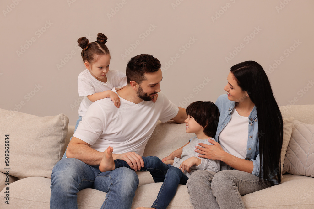 Happy family resting on sofa in living room Happy family resting on sofa in living room