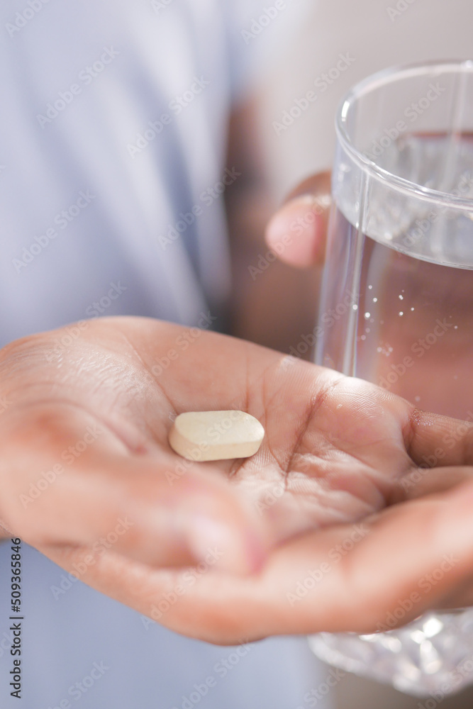 unrecognized man in white shirt taking medicine unrecognized man in white shirt taking medicine
