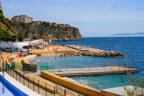Beach of Camp Bay on the western side of the Gibraltar peninsula with a view over the Moroccan mountains in the distance