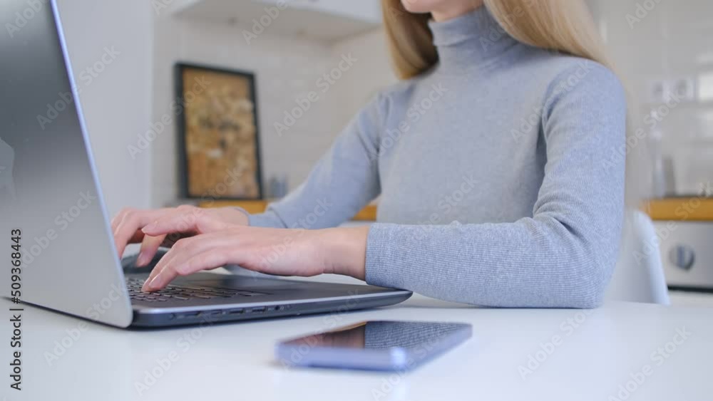 Woman working on laptop. Female person typing text on a computer at home Woman working on laptop. Female person typing text on a computer at home
