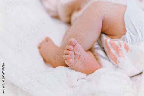 Newborn feet, innocence, maternity and babyhood concept