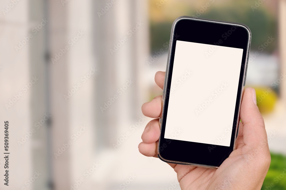 Hand holds phone Sample social media app interface on mobile phone showing shared video content Hand holds phone Sample social media app interface on mobile phone showing shared video content