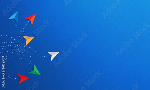 Colored paper planes on blue background. Different vision creative and Innovative solution for Business concepts.
