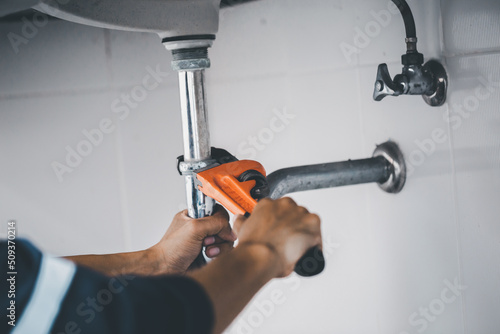 plumber at work in a bathroom, plumbing repair service, assemble and install concept.