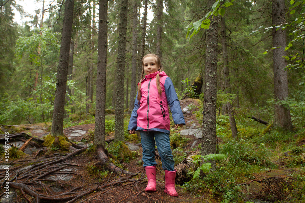 Child girl in forest. Little girl playing outdoors Child girl in forest. Little girl playing outdoors