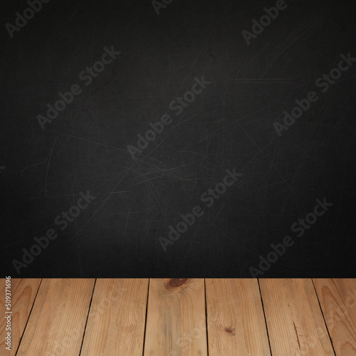 Wooden table top with concrete blackboard wall background for product placement