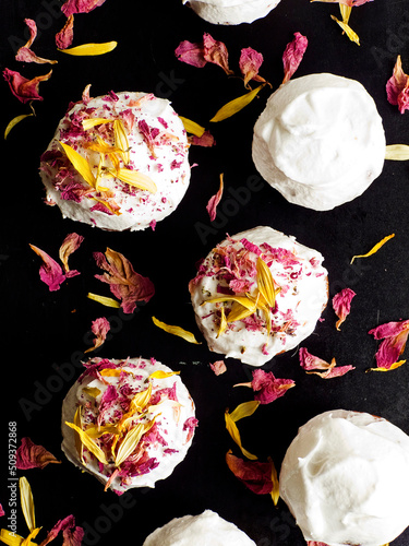 Cake with edible flowers and whipped cream. Shallow dof .