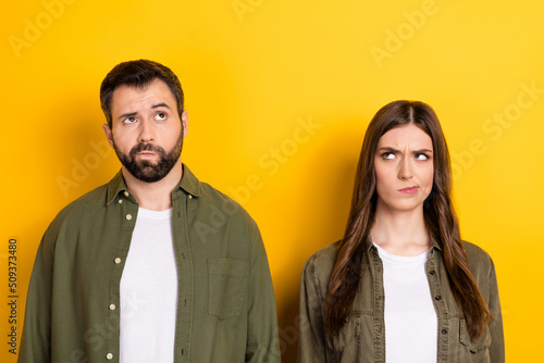 Photo of two minded focused people look interested empty space isolated on yellow color background photo