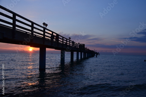 Sunset by the sea scenery, reflections on ripply water surface, blue hour © ClaudiaRMImages