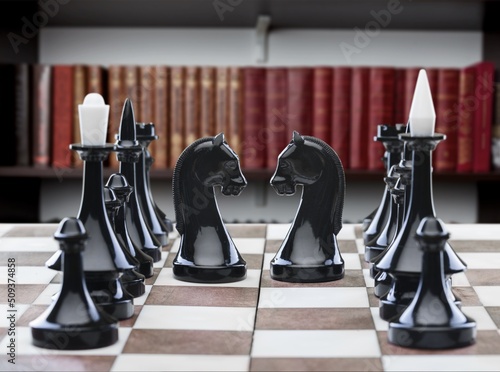 Chess pieces arranged on the chessboard in the room, board games and hobbies concept
