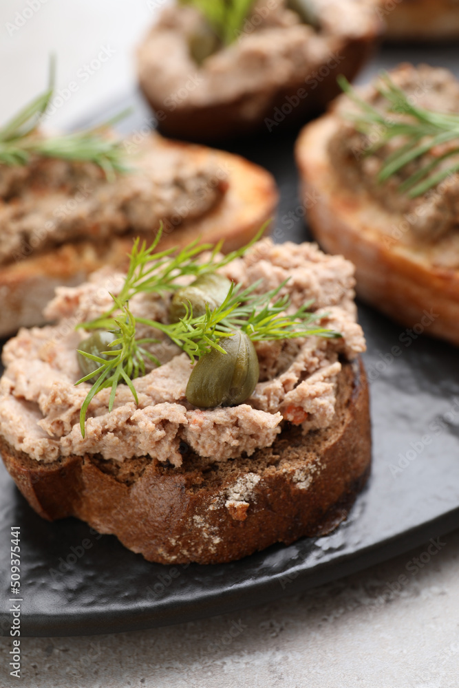 Slices of bread with delicious pate on light grey table, closeup Slices of bread with delicious pate on light grey table, closeup