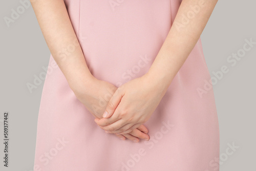 Woman hands holding her crotch suffering from pelvic pain or itchy. Gynecological problems include menstrual disorders, urinary incontinence, genital tract infections, STDs or ovarian cysts. photo