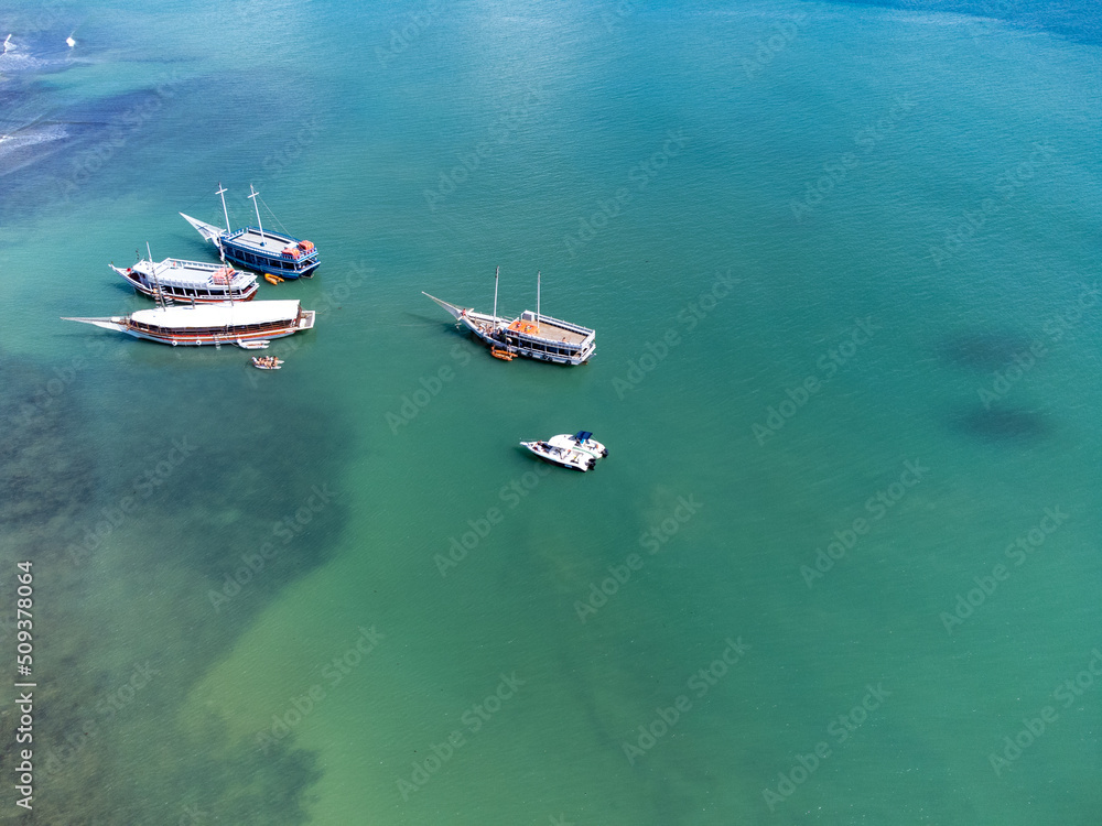 Schooner boat tour on the coral reef in the middle of the sea, Porto Seguro, Bahia, Brazil - natural beauty aerial drone view Schooner boat tour on the coral reef in the middle of the sea, Porto Seguro, Bahia, Brazil - natural beauty aerial drone view