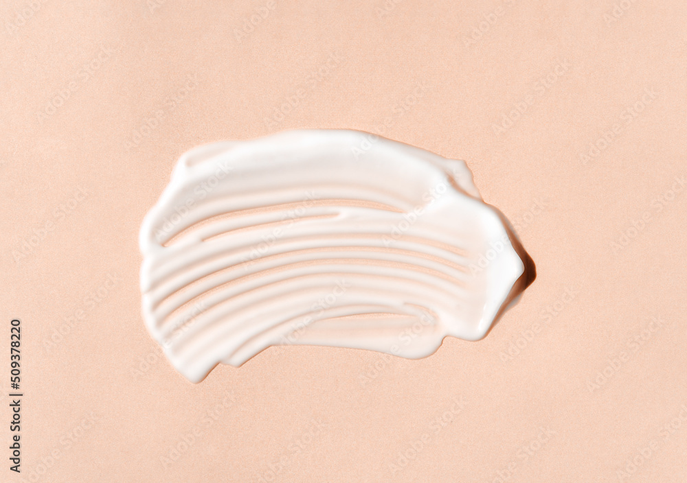 Texture of white cream on beige background. Smear of moisturizer closeup. Lotion swatch. Beauty, skin care product smear smudge drop. SPF sunscreen cream sample Texture of white cream on beige background. Smear of moisturizer closeup. Lotion swatch. Beauty, skin care product smear smudge drop. SPF sunscreen cream sample