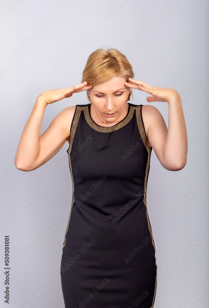 The woman put her fingers to her head and looks down in horror The woman put her fingers to her head and looks down in horror