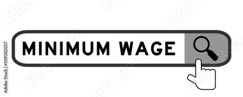 Search banner in word minimum wage with hand over magnifier icon on white background photo