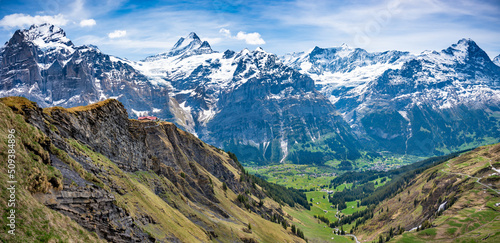 Cliff walk at First peak above Grindelwald village and surrounded snowy Alps. Jungfrau region, Switzerland.