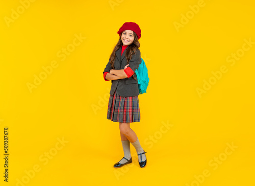 happy child with school bag. teen girl in beret carry backpack. back to school.