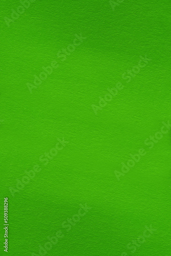 Green gradient background with paper texture. Paper background made of salad-colored cardboard, macro
