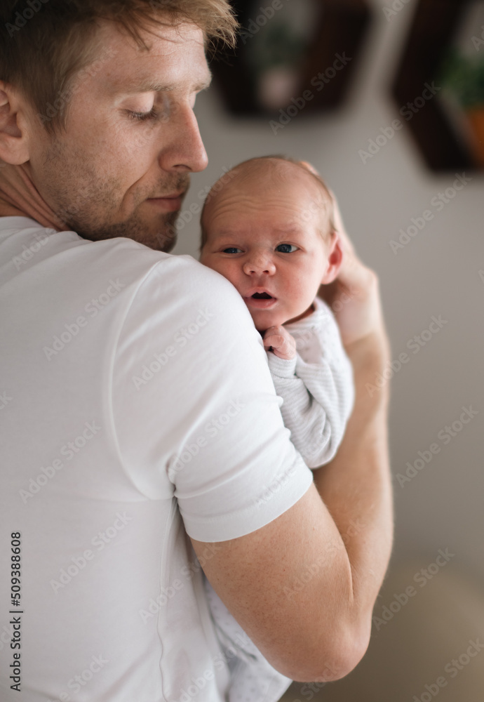 Father holding his newborn son at home. Father holding his newborn son at home.