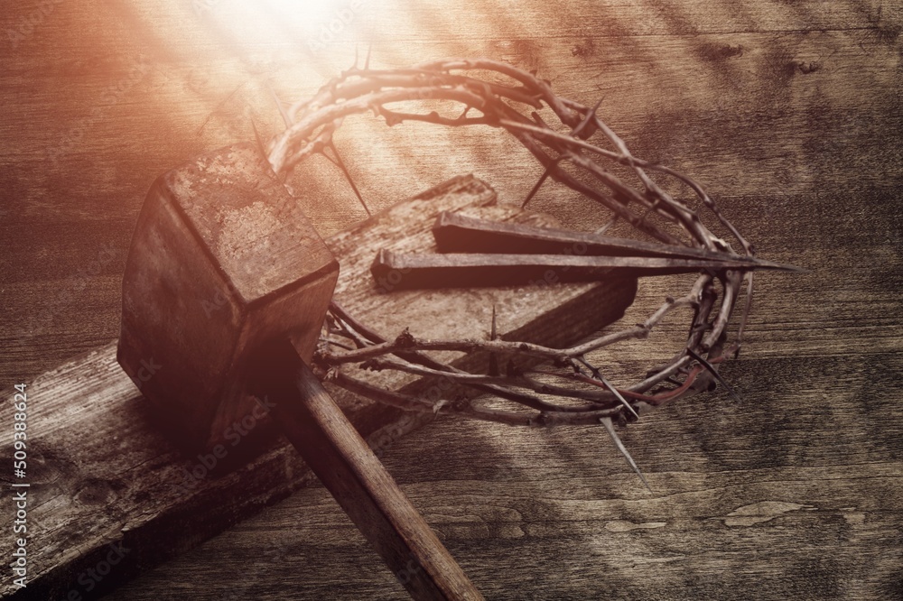 Christ a crown of thorns, on a rustic wooden surface next to a rusty nail Christ a crown of thorns, on a rustic wooden surface next to a rusty nail