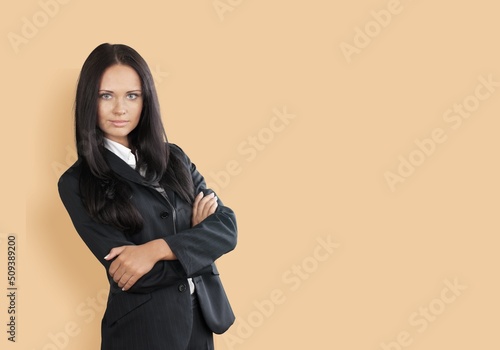Business lady crossed arms wear eyeglasses buisness suit on color background © BillionPhotos.com
