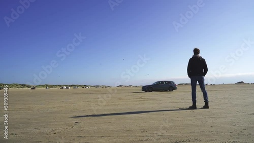 Timelapse of lonely man standing on a beach
