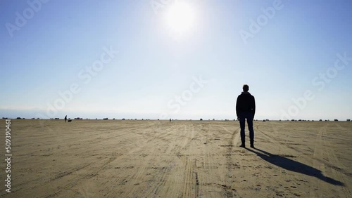 Timelapse of lonely man standing on a beach