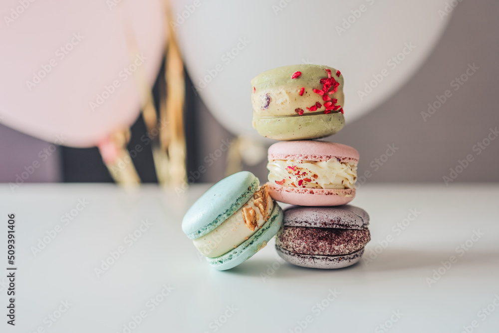 Fototapeta premium Macaroons close-up on a white table in a cafe