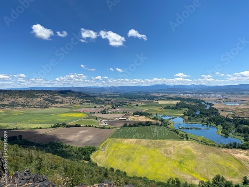 Aerial View of the lush green Rogue Valley in Southern Oregon from atop Table Rock Plateau with fields of green and yellow wildflowers. photo