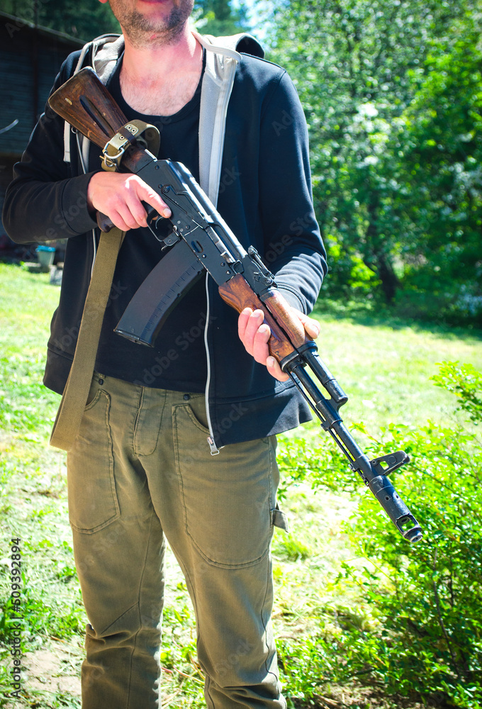 Fototapeta premium An armed man with a machine gun. Ukraine