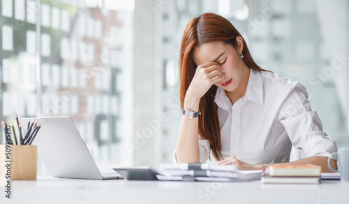 Tired teen girl rubbing dry irritable eyes feel eye strain tension migraine after computer work, exhausted young Asian woman student relieving headache pain, bad weak blurry vision, eyesight problem
