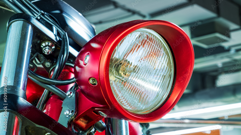 Front headlight of a red motorcycle