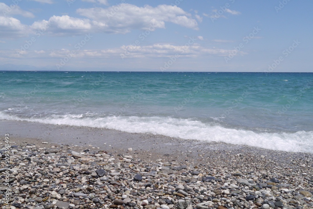 Mediterranean sea coast line with pebbles beach and waves