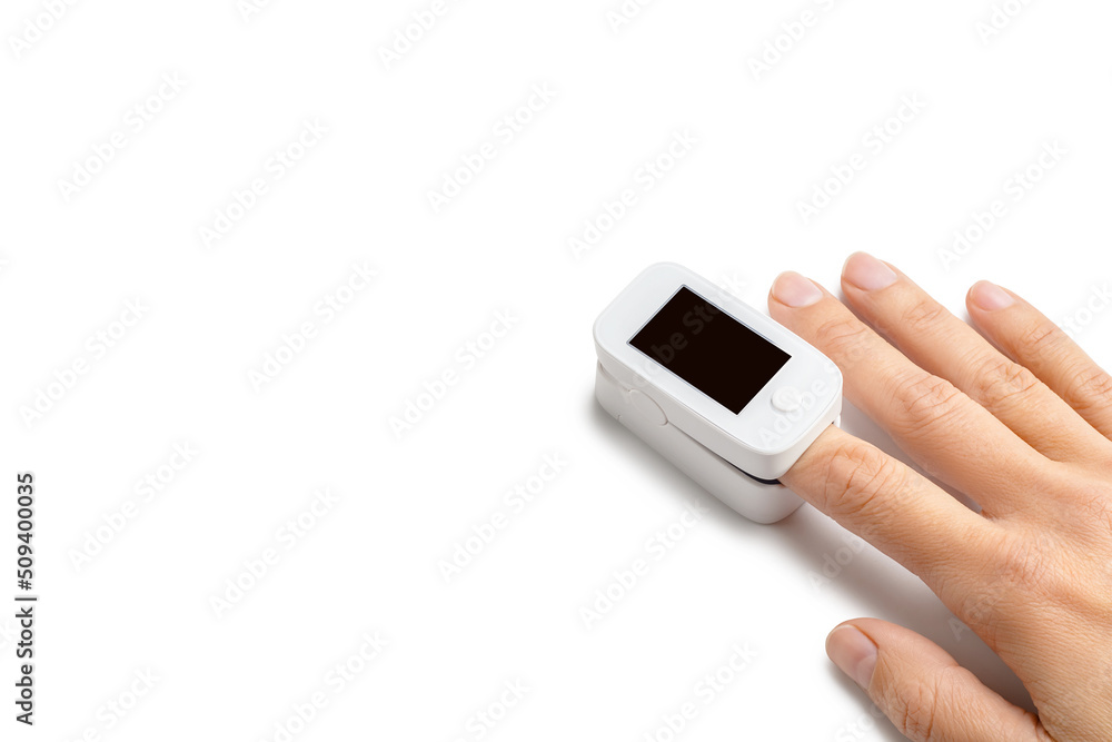 Pulse oximeter on finger to measuring saturation oxygen level and pulse rate isolated on white background, copy space. Pulse oximeter on finger to measuring saturation oxygen level and pulse rate isolated on white background, copy space.