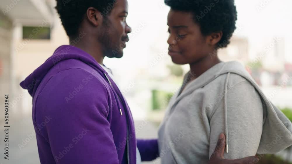African american man and woman couple smiling confident hugging each other at street African american man and woman couple smiling confident hugging each other at street