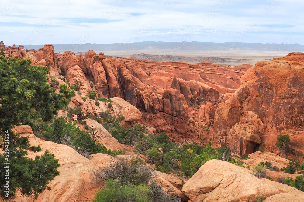 Fototapeta premium View of Fin Canyon on the Devil's Garden trail in the Arches National Park, Utah, USA. Sandstone rock geological formations in Utah desert. Hiking in the American southwest on a nice day of spring.