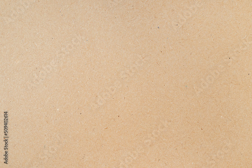 Smooth clean blank sheet of light brown cardboard as texture or background