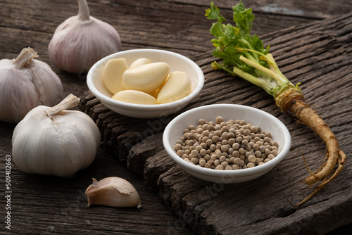 Close up white pepper  garlic and cilantro root.Three key ingredients known as    Sam Kler    Thai Seasoning