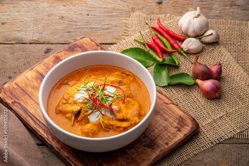 Panaeng Curry with chicken.Sliced chicken breast Meat in red curry paste and coconut milk,topping with coconut cream and Shredded kaffir lime leaves.Thai style food. photo