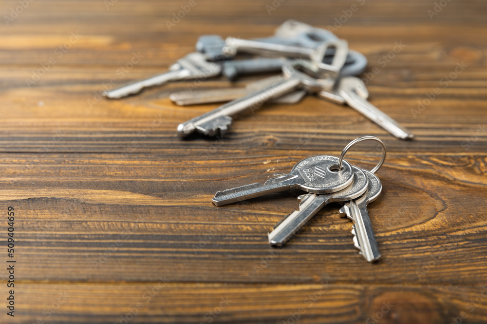 House keys. Composition on brown texture wood. Design element. Real estate and insurance concept. Copy space. House keys. Composition on brown texture wood. Design element. Real estate and insurance concept. Copy space.