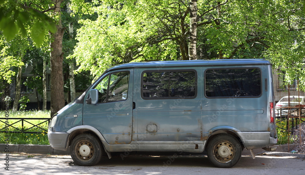 An old rusty blue minibus parked in the courtyard, Antonova-Ovseenko Street, St. Petersburg, Russia, May 2022 An old rusty blue minibus parked in the courtyard, Antonova-Ovseenko Street, St. Petersburg, Russia, May 2022