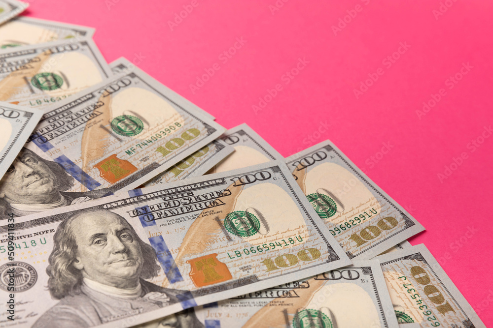 Money, stacks of US hundred dollar bills on a pink background. Money is scattered on the table. Concepts of finance and economics. Money saving concept. currency savings. Investments. copyright. Money, stacks of US hundred dollar bills on a pink background. Money is scattered on the table. Concepts of finance and economics. Money saving concept. currency savings. Investments. copyright.