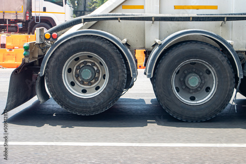 View of the rear wheels of a truck while driving with the rear axle raised