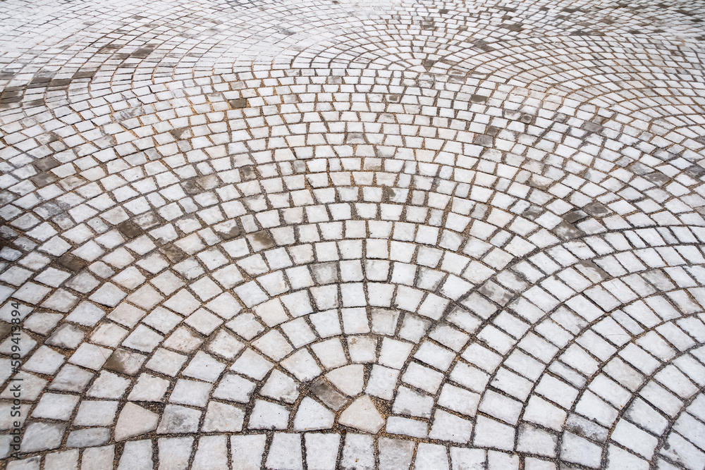 Square stone for paving the surface of the walkway.