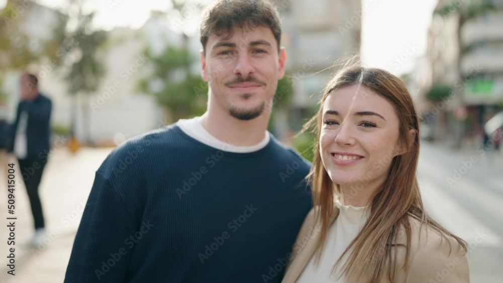 Young couple standing together kissing at street Young couple standing together kissing at street