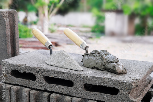 Cement or mortar, Cement mix or cement powder with a trowel put on the brick for construction work.